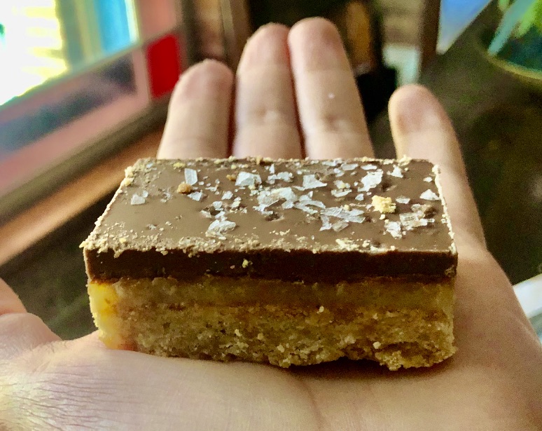 hand holding caramel slice