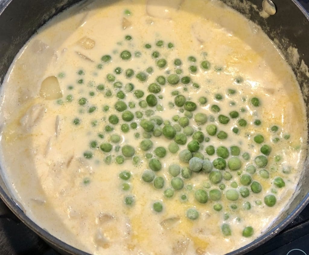 adding peas to the wasabi soup