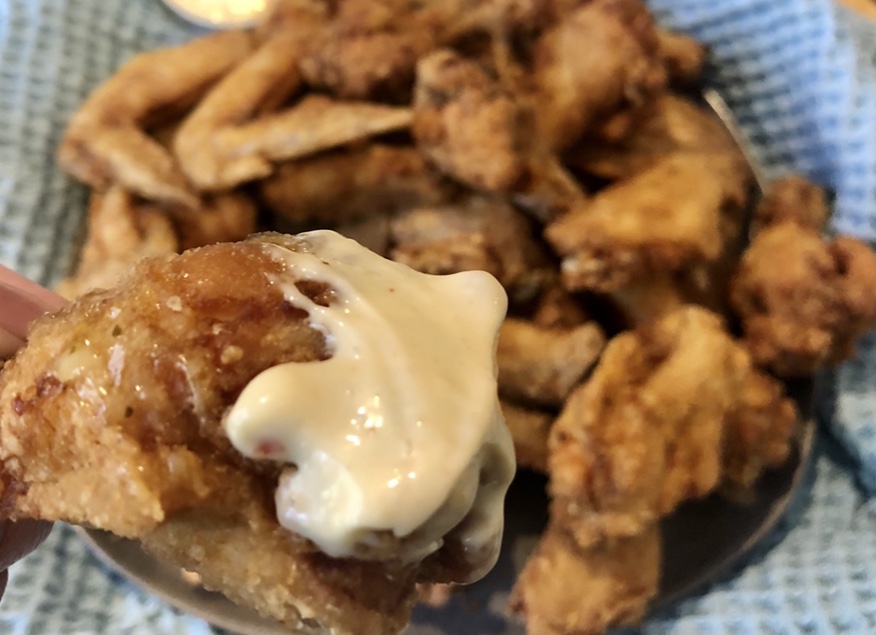 fried chicken dipped in sauce