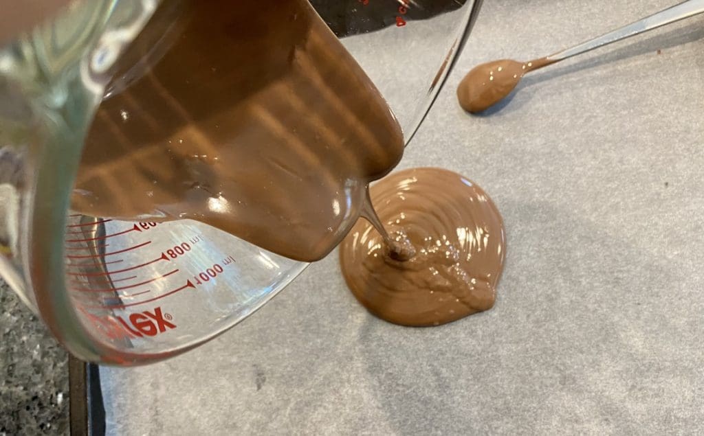pouring chocolate into baking tray