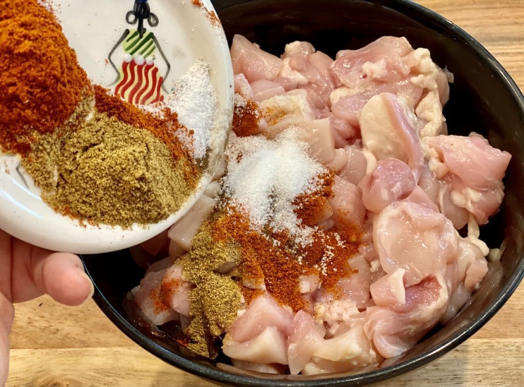 adding mexican spices to the chicken
