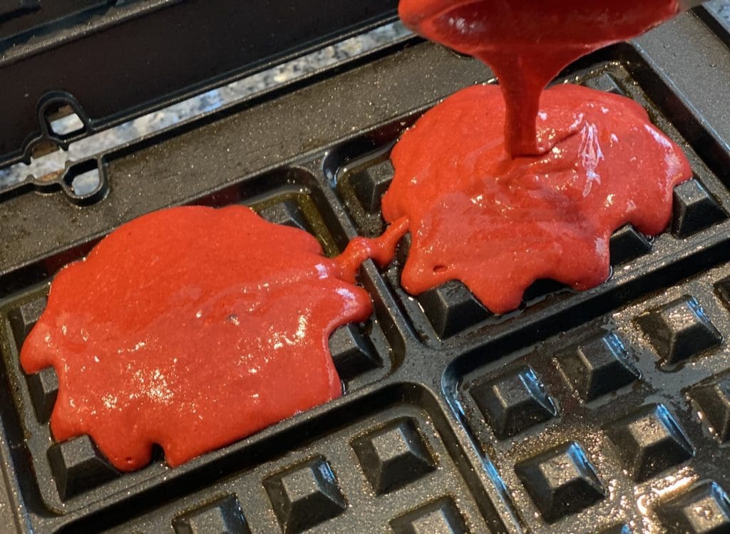 cooking the red velvet waffles