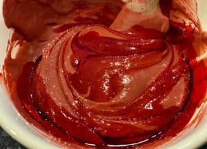 mixing red colouring into batter