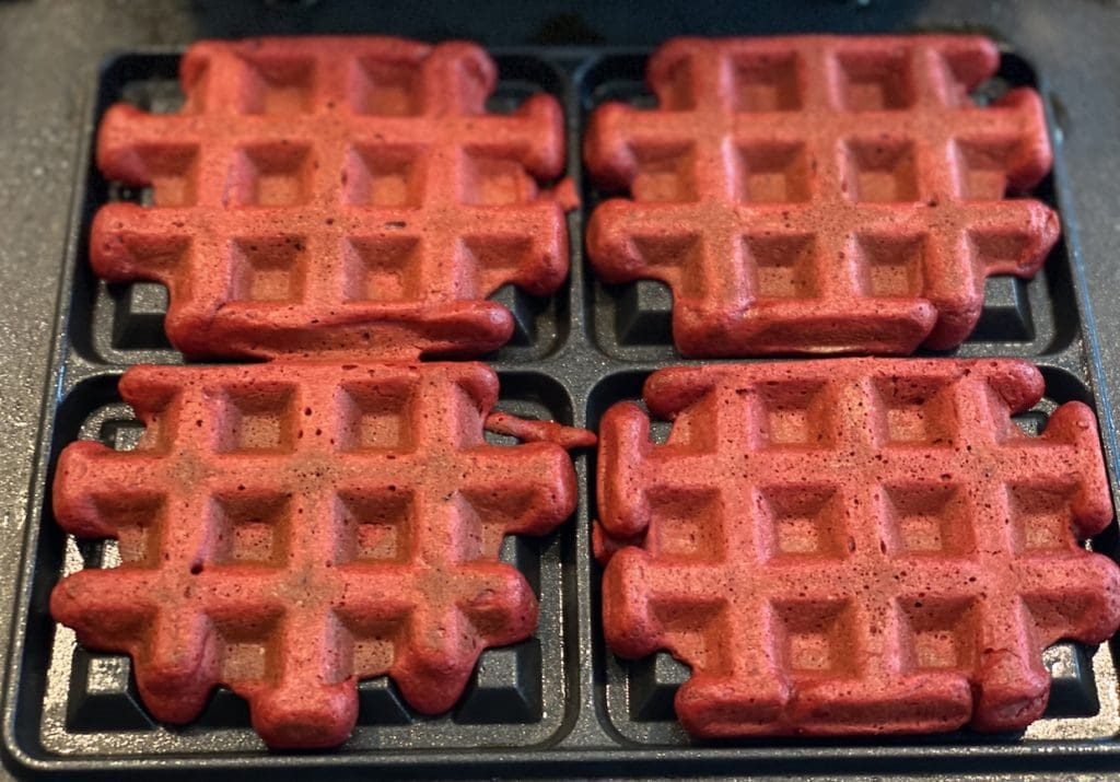 cooking the red velvet waffles