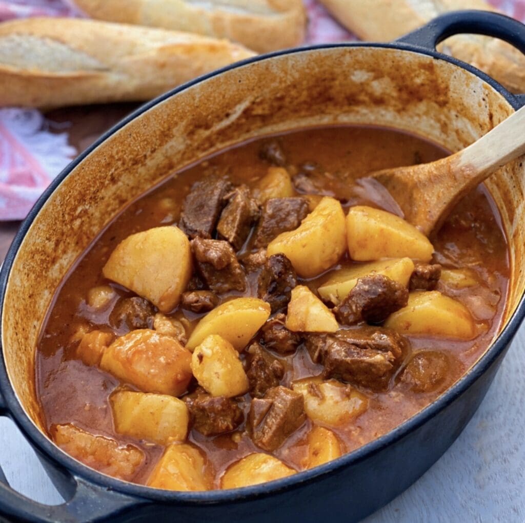 Classic beef and potato stew cooked low and slow, served in a rustic cast iron casserole