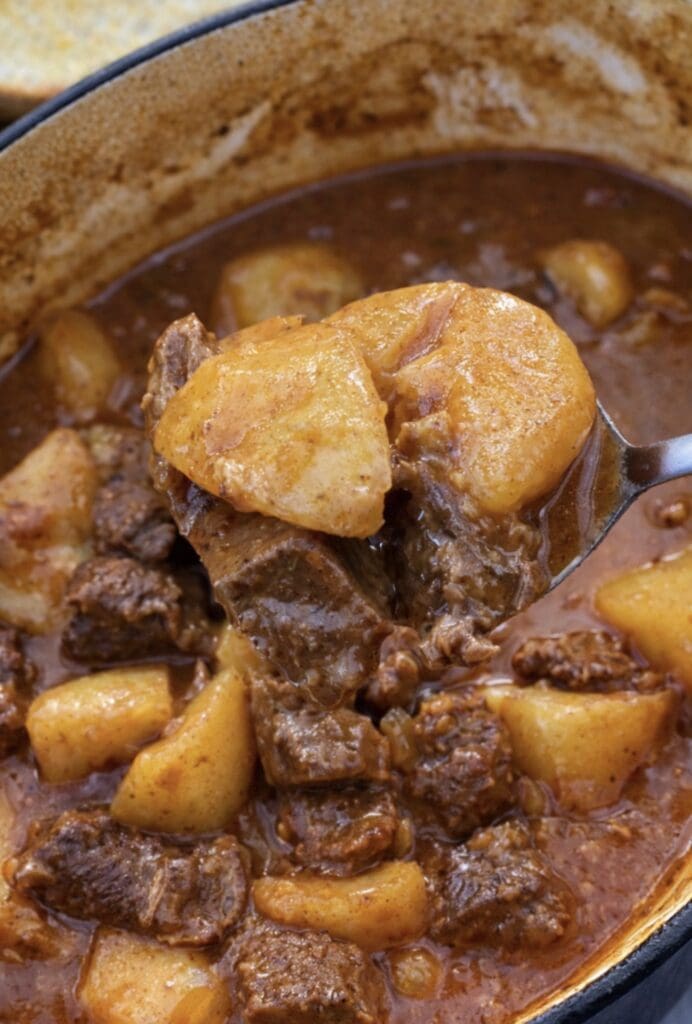 Homemade beef and potato stew with tender beef chunks and potatoes in a thick, comforting sauce.