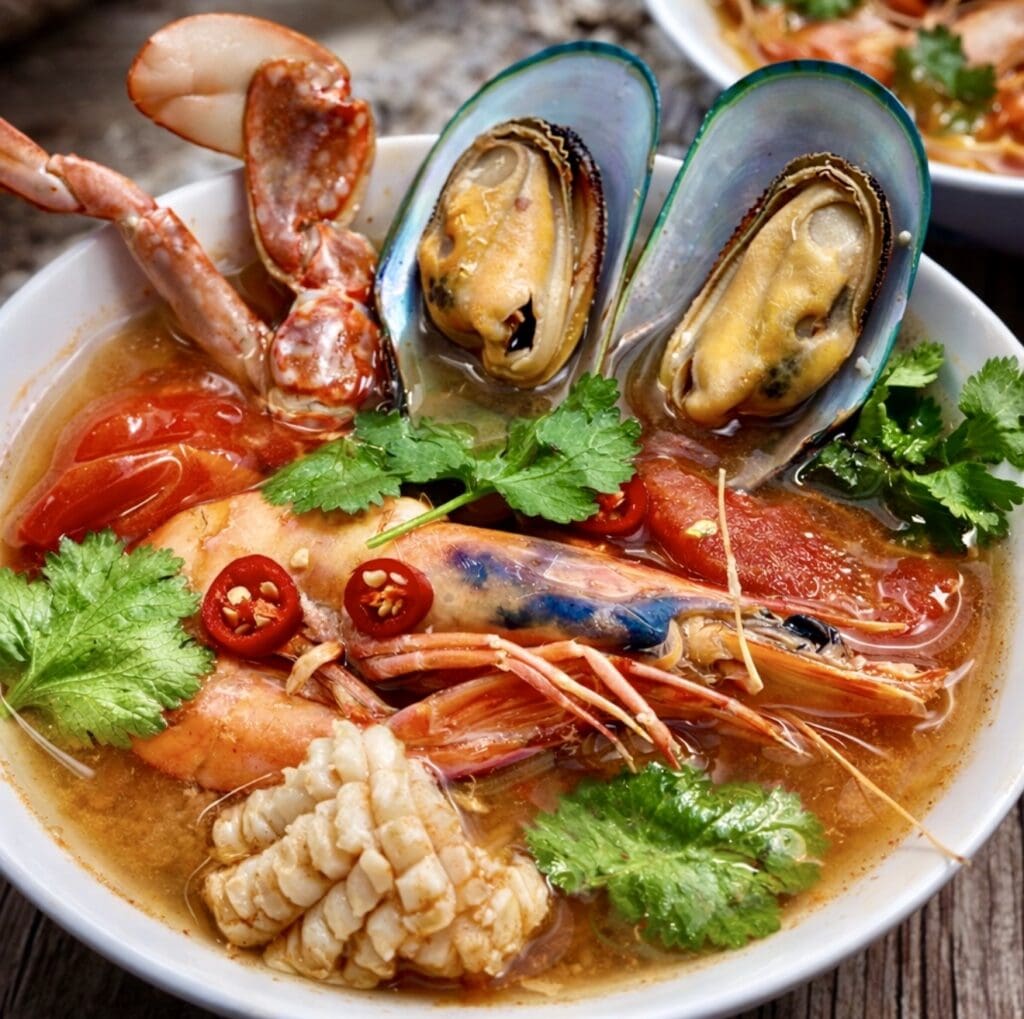Thai seafood soup with prawns, mussels, crab and squid in a hot and sour Tom Yum broth