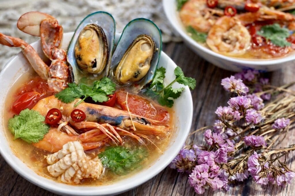 Thai seafood soup with prawns, mussels, crab and squid in a hot and sour Tom Yum broth