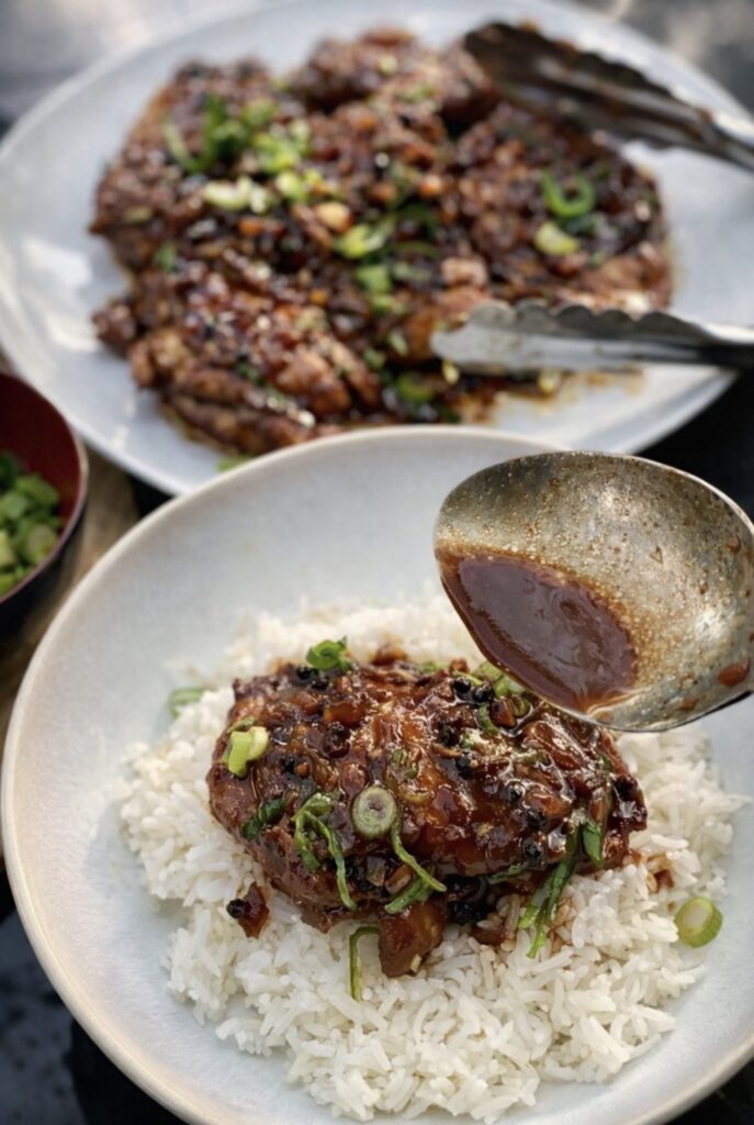 Filipino chicken adobo cooked in a rich soy and vinegar sauce with bay leaves and peppercorns