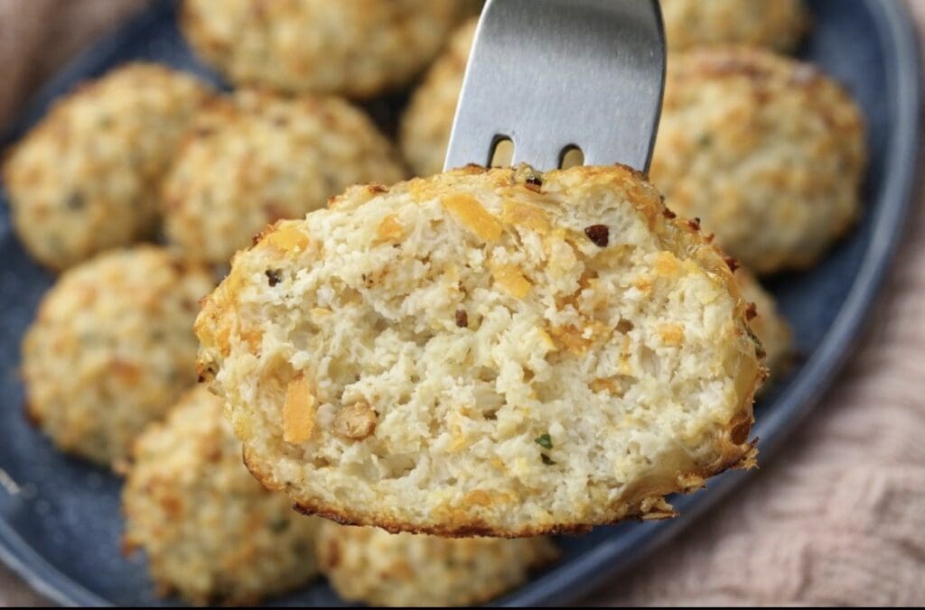 Chicken meatball for baby cut in half on a fork showing the soft inside.