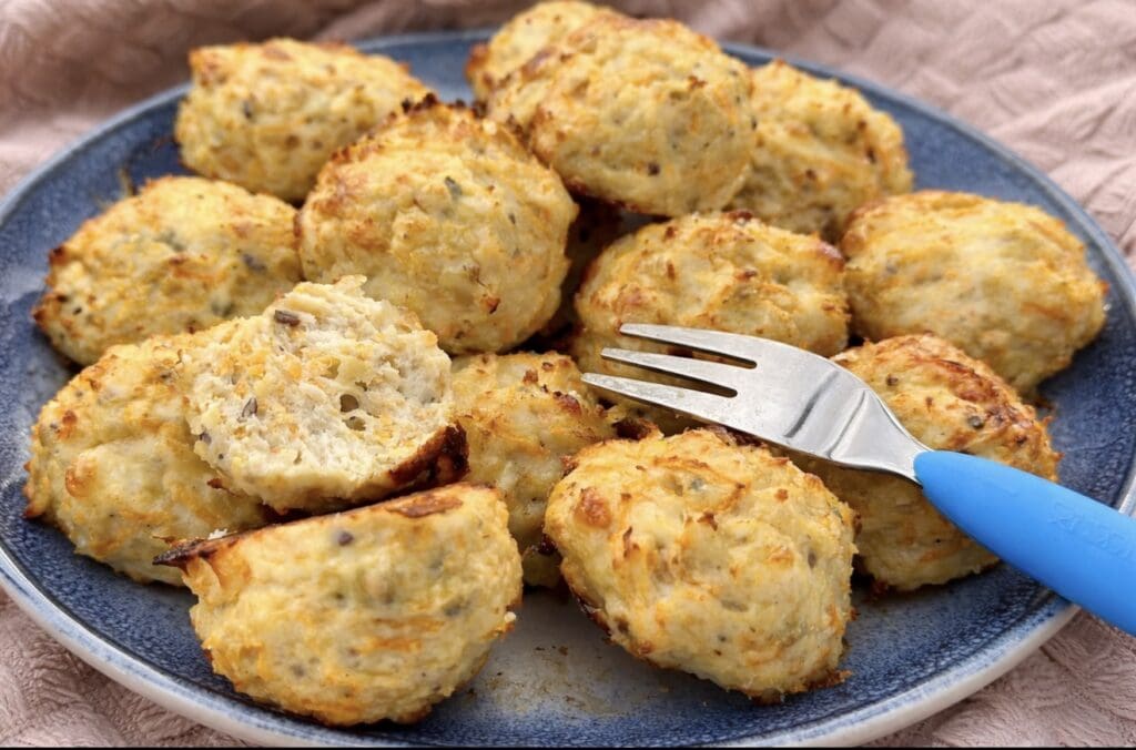 Close-up of a baked chicken meatball for baby cut open on a fork, showing a soft, tender interior, suitable for babies and toddlers.