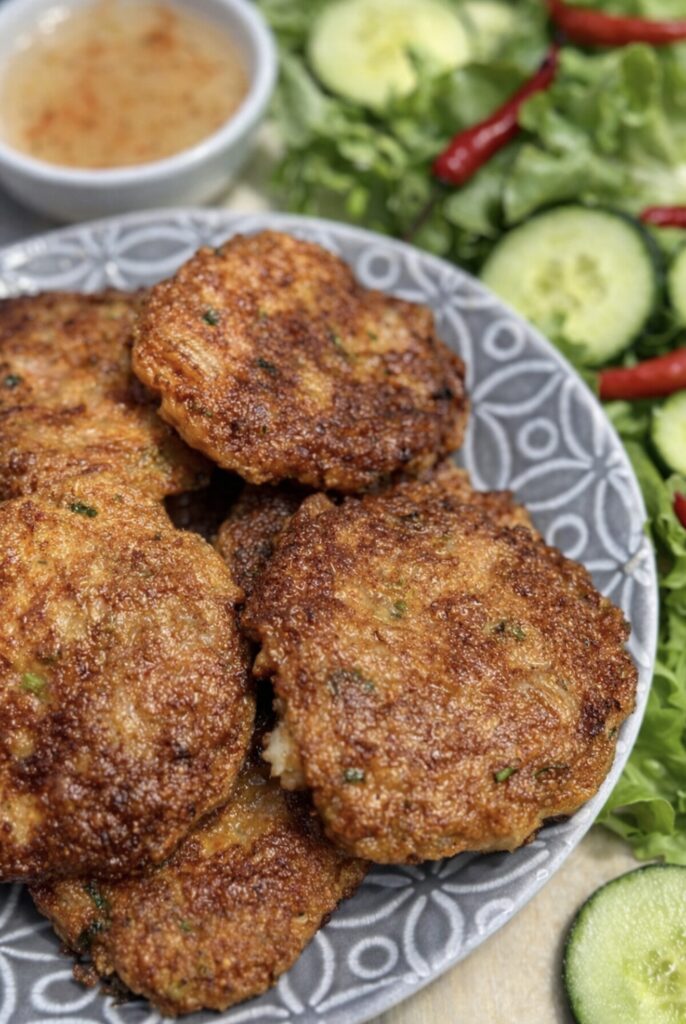 Close up of crispy Thai Fish Cakes with Prawns showing golden brown crust and tender interior.