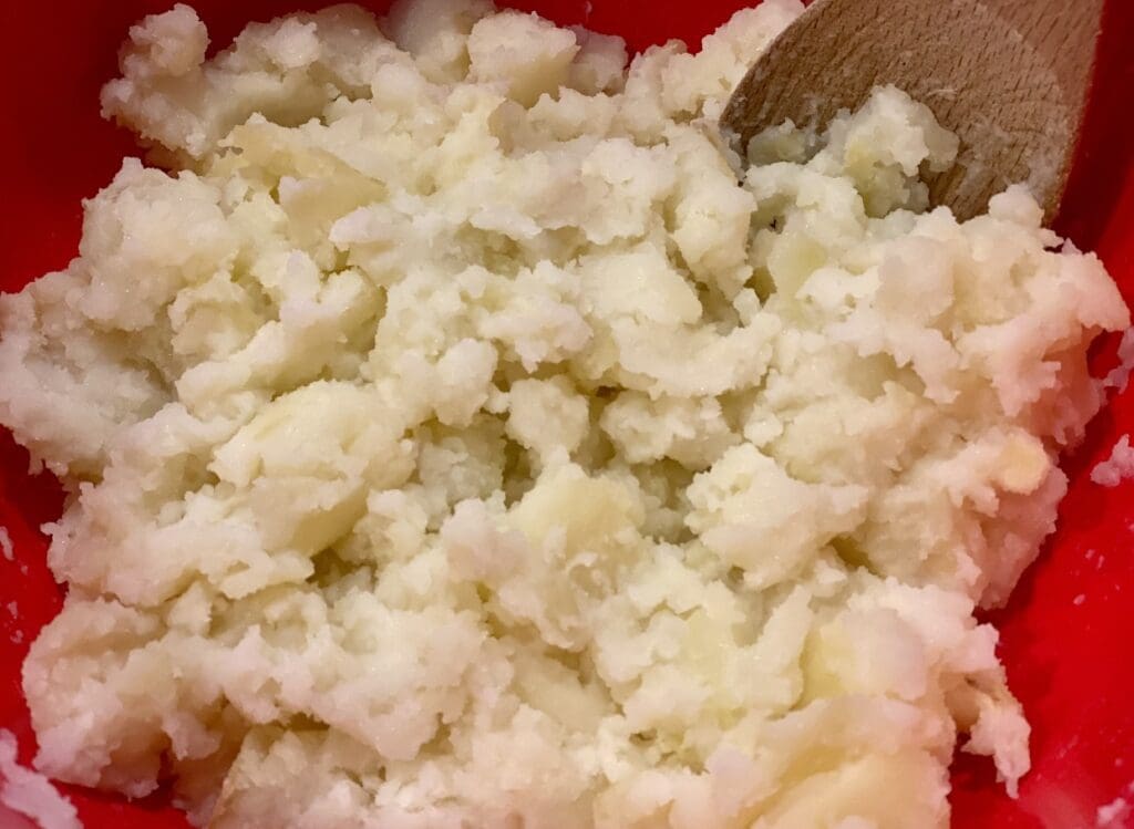 mashing the potatoes