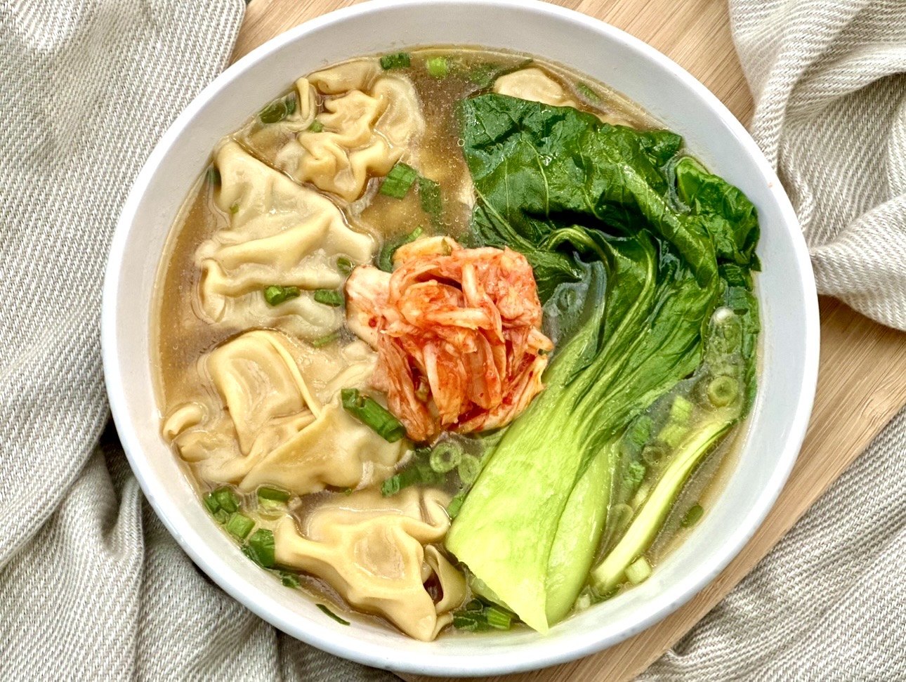 Juicy and flavourful Kimchi Dumplings served in a simple soup with bok choy