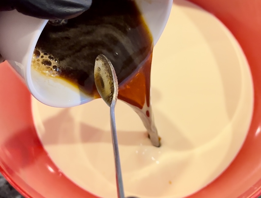 mixing coffee into cream