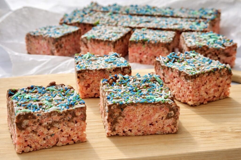 Rice bubble slice with brown butter and chocolate, cut into neat squares and topped with sprinkles