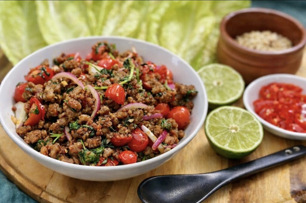 A platter with lime, chillies and a bowl of mince, ready to made into Asian Lettuce Wraps