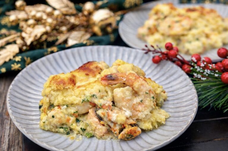 Slice of luxury seafood pie served on a plate with creamy seafood filling and golden mashed potato topping