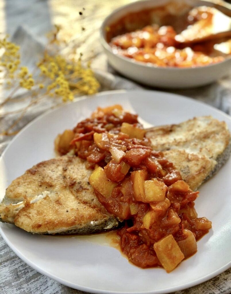 Tender fish cooked served with chunky tomato sauce with onions, yellow capsicum and olive oil