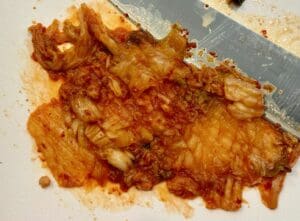 chopping kimchi