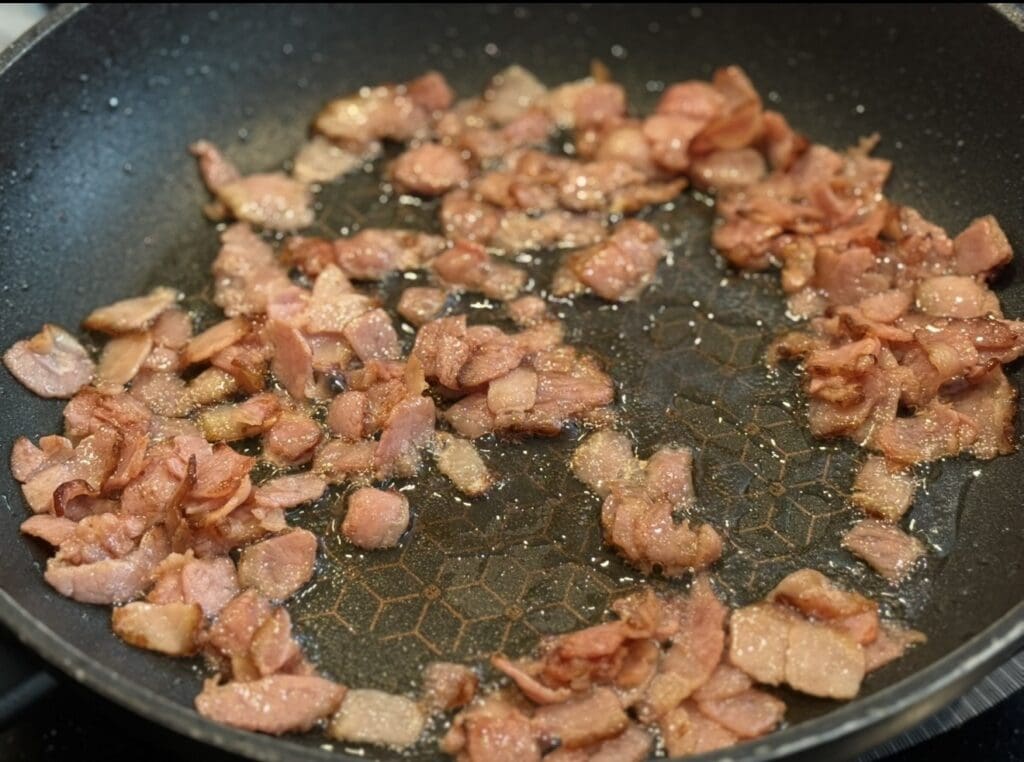 Frying bacon in a pan until golden brown