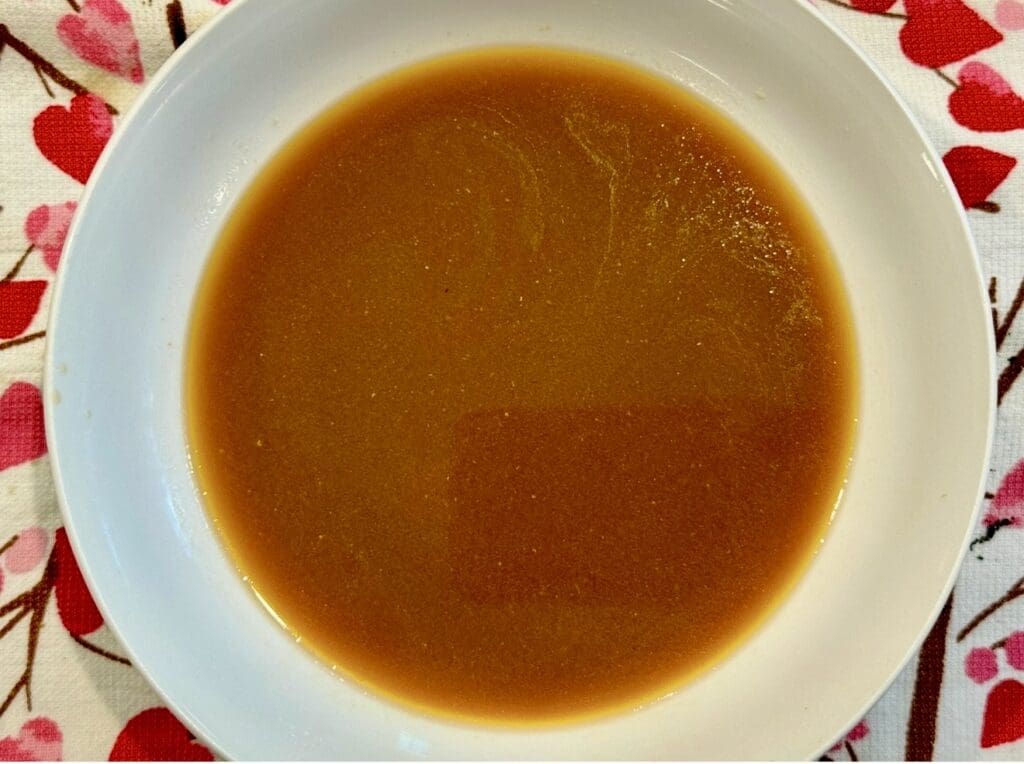 The marinade after removing the herbs and spices