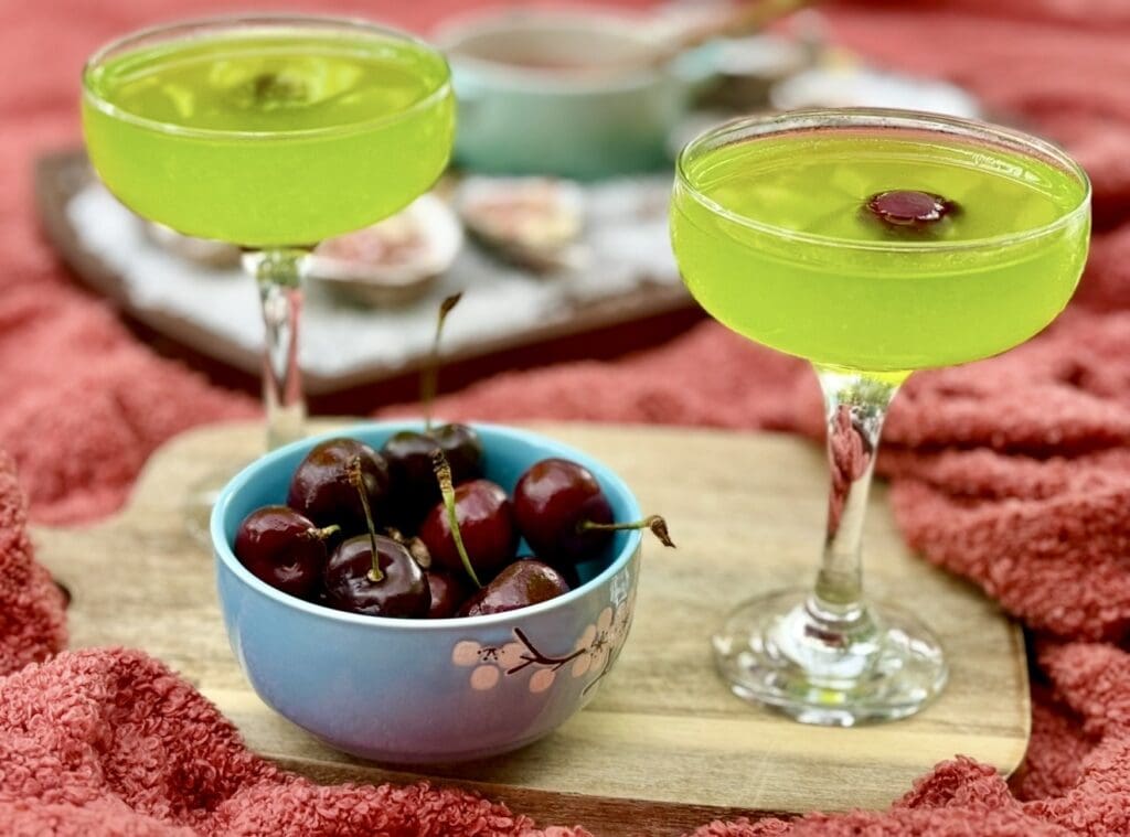 Classic Japanese Slipper Cocktail with Midori liqueur, lemon juice and cherry garnish