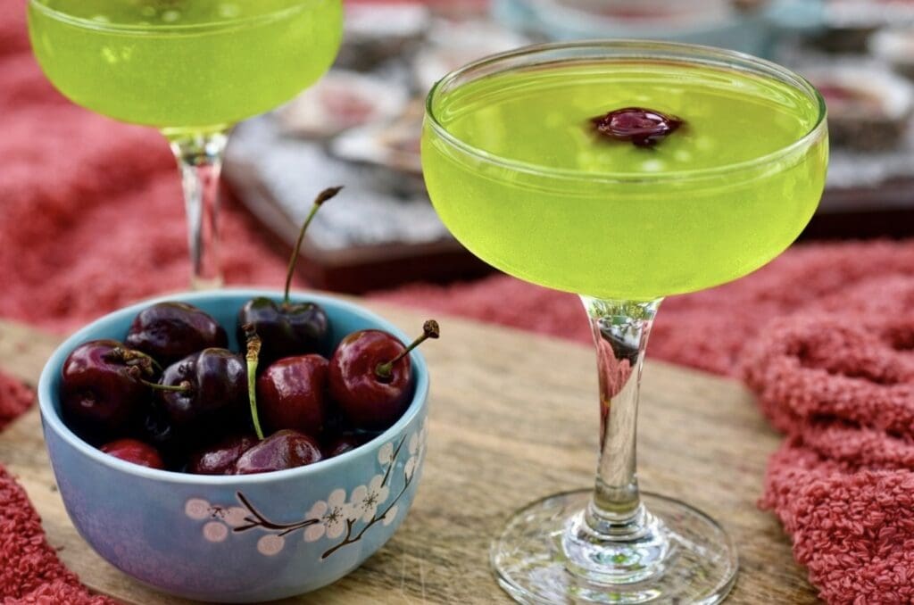 Japanese Slipper Cocktail made with Midori, Cointreau and fresh lemon juice, garnished with a cherry