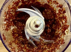 Blended bacon and onion mixture in a food processor for rich homemade bacon dip