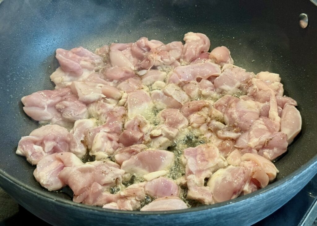 Chicken thigh fillets in a single laye,r browned over high heat until a crust forms