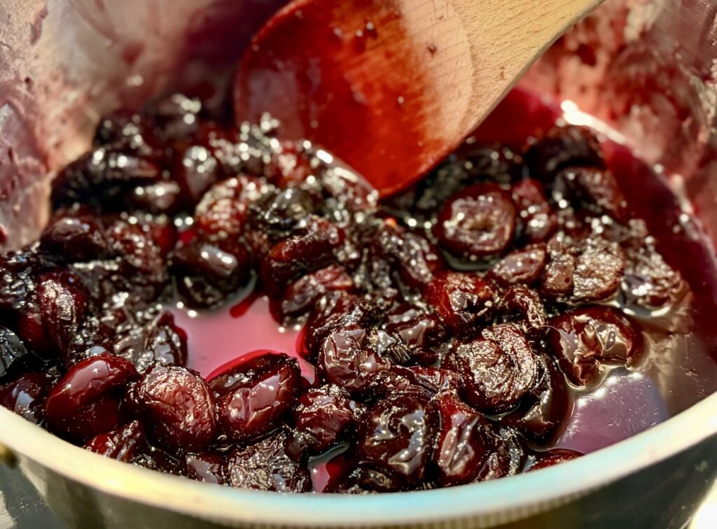 The softened cherries after the reduced liquid
