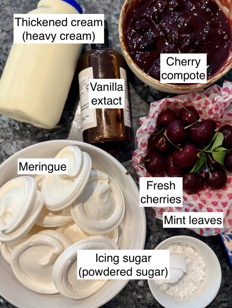 Ingredients needed to make Eton Mess with cherry compote displayed on kitchen bench