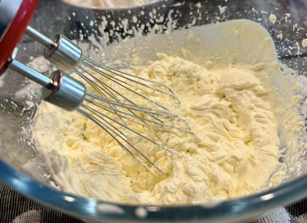 Whipping the cream, sugar and vanilla together for Eton Mess