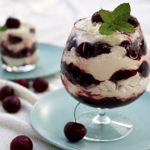 Cherry Eton mess layered with whipped cream, cherry compote, and meringue pieces