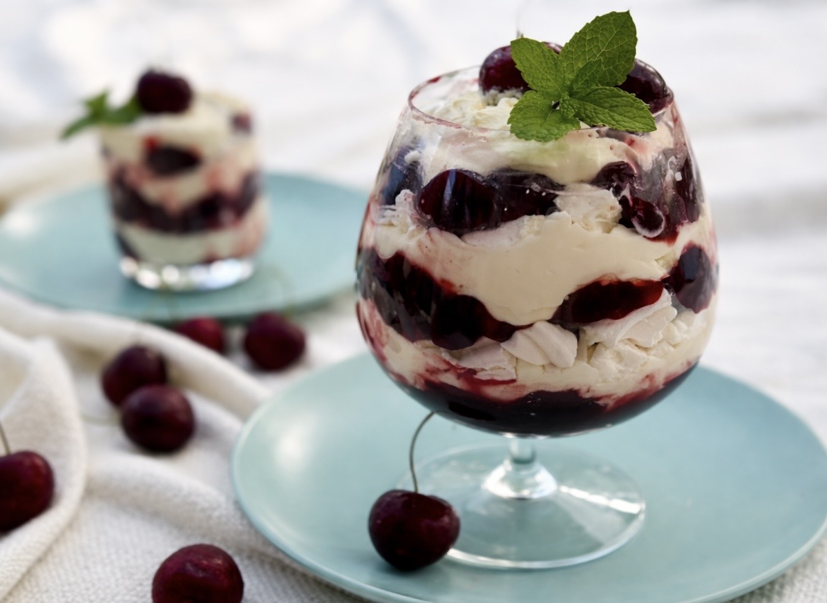 Cherry Eton mess layered with whipped cream, cherry compote, and meringue pieces